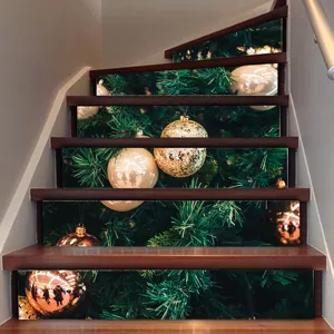 Detail showing 3D Christmas tree staircase stickers with festive gold baubles on wooden stairs