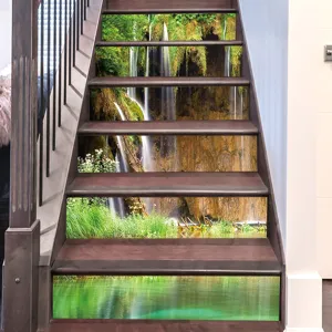 Detail of 3D waterfall landscape self-adhesive stair riser stickers on wooden stairs.