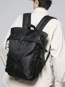 Modern black roll-top business commute backpack for men shown in a casual style