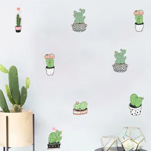 Detailed view of cute cartoon cactus wall stickers on a minimalist light grey wall