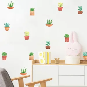 Detail of watercolor succulent wall stickers applied to a bright nursery or bedroom wall.