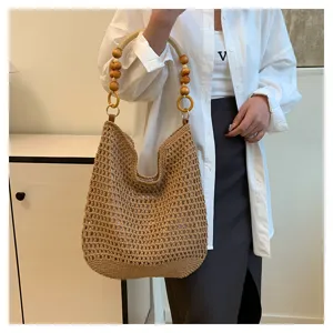 Vue détaillée du sac hobo en maille tissé main beige avec anse en perles de bois