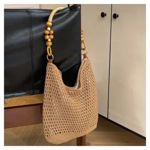 Détail d'un sac cabas en maille fait main avec poignée en perles de bois naturel