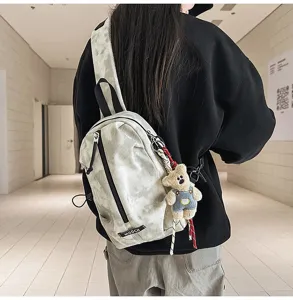 Outdoor cycling chest bag with tie-dye pattern and cute bear charm worn by a model