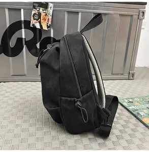 Side detail view of a black casual outdoor crossbody chest bag with breathable mesh strap.