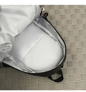 Macro view of the internal compartment and pocket of a black outdoor chest bag