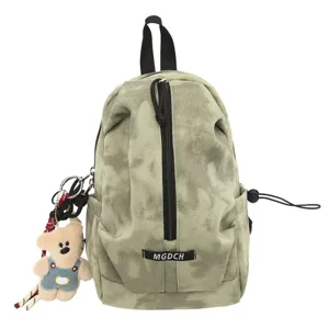 Detailed view of tie-dye canvas messenger bag with a cute bear charm