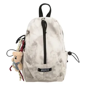 Detailed close-up view of casual marble pattern sling bag featuring a cute plush bear charm