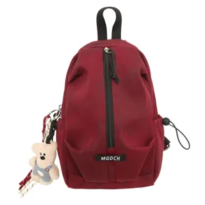 Front view of a maroon casual sling bag featuring a vertical zipper and a bear charm