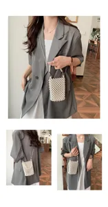 Detailed views of a handmade white pearl beaded crossbody phone bag worn with a grey blazer.