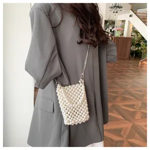 Elegant handmade white pearl beaded crossbody phone bag with a sleek silver chain strap