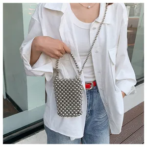 Trendy silver handmade beaded crossbody phone bag shown on a model's white shirt