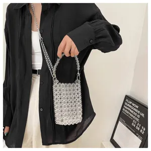 Model wearing a stylish transparent beaded crossbody phone bag with a metal chain strap
