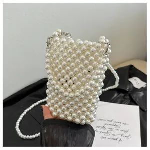 Close-up detail of a handmade white pearl beaded mini crossbody bag for mobile phones