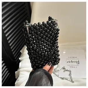 Hand-woven black beaded crossbody phone bag with silver chain strap detail