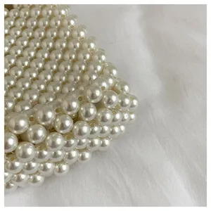 Macro close-up shot showing the intricate texture of a cream white woven pearl bag