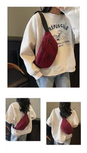 Detaillierte Ansichten der weinroten Umhängetasche, getragen über einem lässigen weißen Sweatshirt