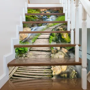 Close-up of 3D landscape stair stickers featuring a flowing stream and wooden bridge