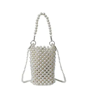 Detail showing the delicate hand-woven pearl bead texture of this elegant crossbody phone bag.