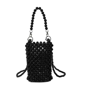 Detailed macro shot of a black handmade beaded woven phone purse and crossbody bag