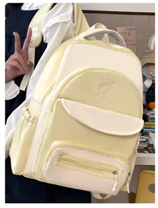 Large capacity cream yellow preppy student backpack featuring cute cat embroidery details.