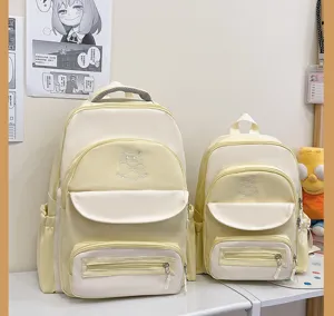 Comparison of two sizes of cute color-block school backpacks in cream and yellow tones.