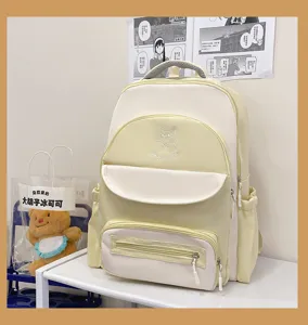 Detailed view of casual academy style color-block student backpack with cat logo