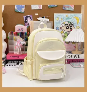 Yellow and white college style school backpack shown in a lifestyle desk setting