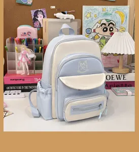 Close-up of a kawaii color-block student backpack featuring cute cat embroidery
