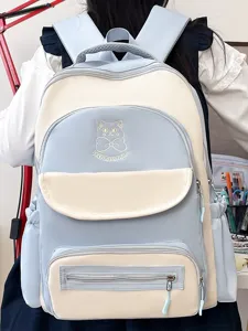 Cute academic style blue and beige color-block school backpack with cat pattern embroidery
