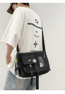 Detailed side view of a black nylon crossbody messenger bag with functional pockets