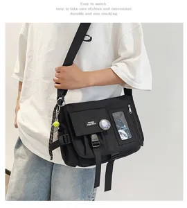 Close-up of a trendy black nylon messenger bag with multiple pockets and a wide strap