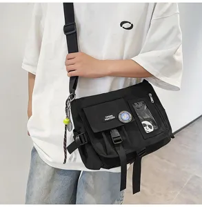 Detail view of a black nylon messenger bag for students with a trendy streetwear vibe