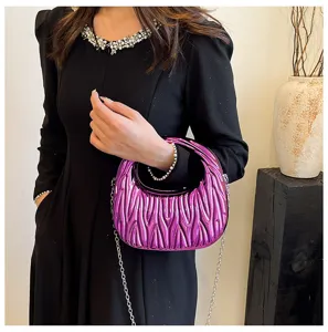 Elegant metallic purple matelasse handbag with silver chain strap shown on black dress.