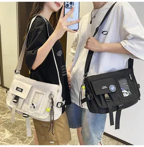 Detailed view of unisex techwear nylon messenger bags in black and off-white colors