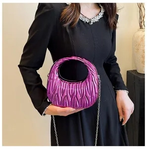 Stylish metallic purple acrylic quilted handbag with elegant chain strap shown on model