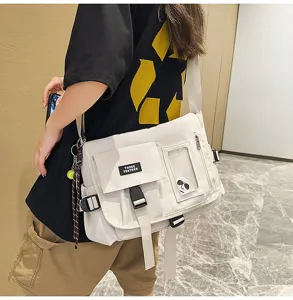 Detailed view of white nylon messenger bag in trendy workwear style for travel use