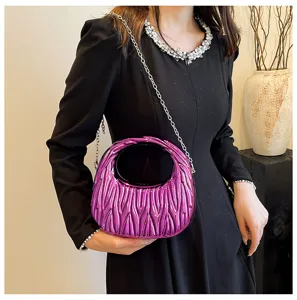 Close-up of a stylish purple acrylic handbag with pleated texture and silver chain strap