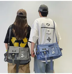 Detailed macro view of grey and blue nylon messenger bags with industrial buckle design