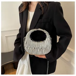 Close-up detail of silver acrylic pleated handbag with metallic chain strap