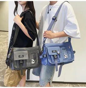 Detailed view of unisex nylon messenger bag in grey and blue with multiple pockets