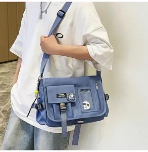 Detailed view of a trendy blue nylon messenger bag worn by a student in a casual street style