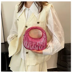 Metallic pink matelassé handbag featuring a silver chain strap and circular top handle