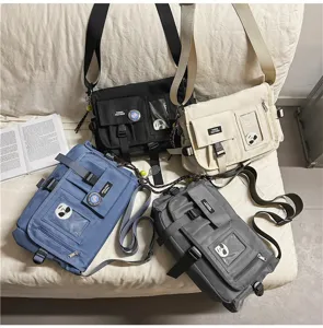 Detailed view of four colorful nylon utility messenger bags in a lifestyle setting