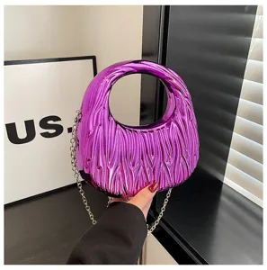 Close-up of a metallic purple wavy-textured acrylic handbag with silver chain strap