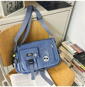 Blue nylon messenger bag with adjustable strap and multiple pockets in casual setting