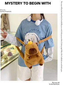Cute capybara plush backpack for kids shown worn by a model in a trendy cafe setting.