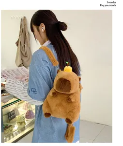 Cute plush capybara backpack with orange detail worn by woman in a cafe setting