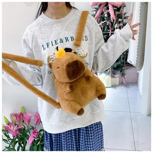Plush capybara backpack for kids featuring a cute orange head accessory on a young girl model