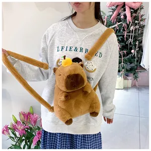 Cute cartoon Capybara plush animal backpack worn by a model in a cozy festive setting